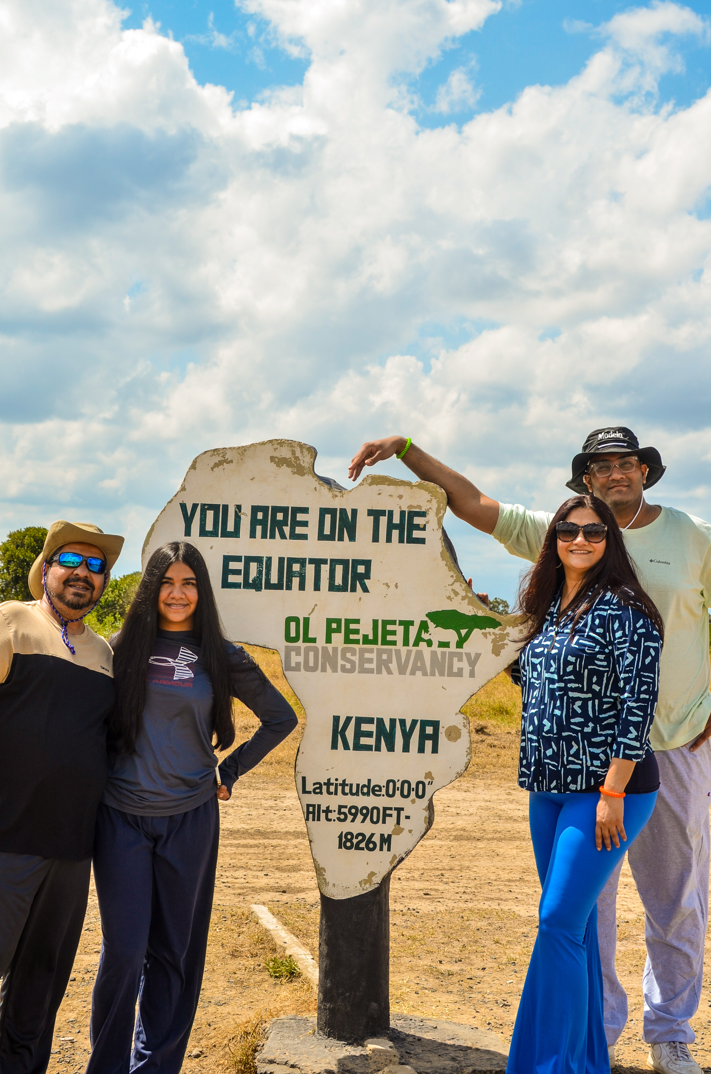 Family at the Equator sign, Ol Pejeta Conservancy