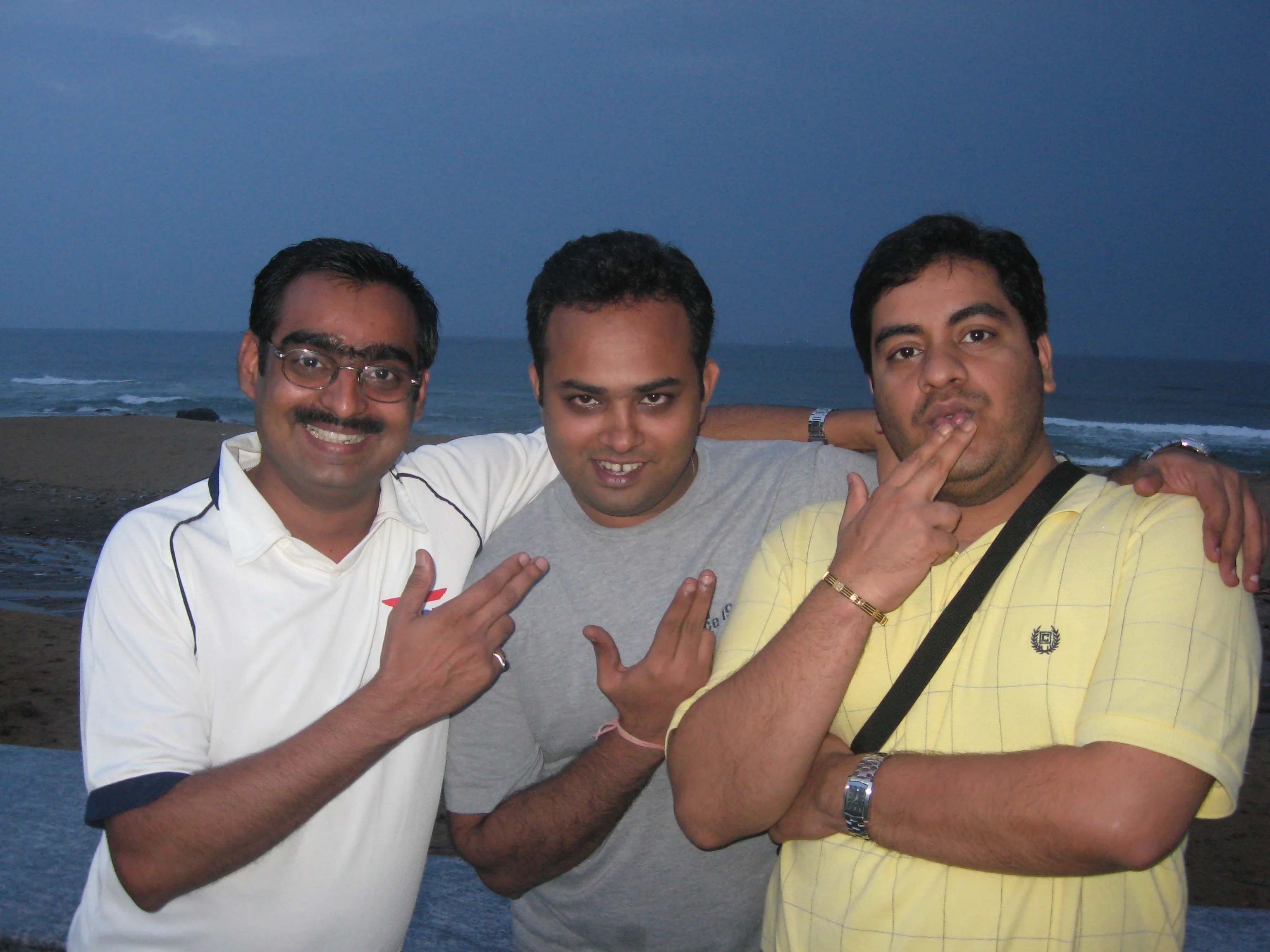 Kaka, Adi, and Navin on a beach at dusk in the late 90s